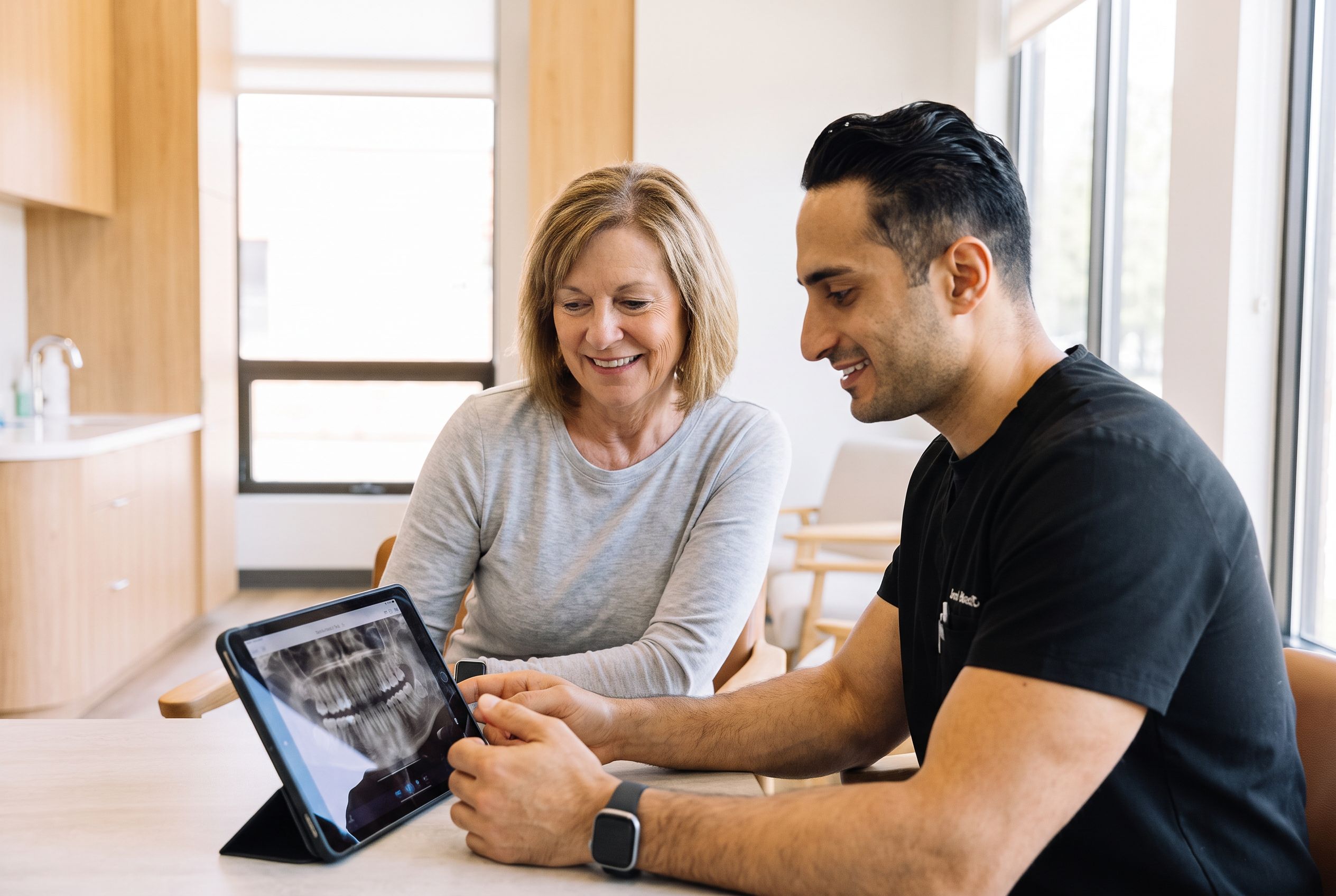 Dr. Moradian showing a patient her x-ray on a tablet